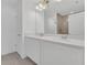Bathroom with dual sinks, large mirror, white countertops and shower with glass door at 1620 Pelican Dr, Davenport, FL 33896