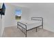 Bright bedroom featuring a black metal bed frame, plush carpet, and a window offering natural light at 1620 Pelican Dr, Davenport, FL 33896