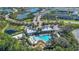 Aerial view of a resort-style pool, recreation area, and landscaping in residential community at 1620 Pelican Dr, Davenport, FL 33896