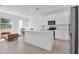 Bright open kitchen with stainless steel appliances, island, and white cabinetry at 1620 Pelican Dr, Davenport, FL 33896
