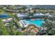 An aerial view of a community pool, mini golf and surrounding greenery create an inviting recreational space at 1620 Pelican Dr, Davenport, FL 33896