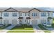 Exterior view of modern townhomes with attached garages, fresh landscaping and stylish curb appeal at 1620 Pelican Dr, Davenport, FL 33896