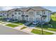 Exterior view of modern townhomes with attached garages, fresh landscaping and stylish curb appeal at 1620 Pelican Dr, Davenport, FL 33896