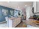 Modern kitchen boasts stainless steel appliances, granite counters, and stylish blue accent wall at 1811 Waggoner St, Kissimmee, FL 34744