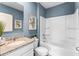 Bright bathroom with a granite vanity top and a modern shower-tub combination at 1815 Waggoner St, Kissimmee, FL 34744