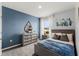 Charming bedroom featuring a gray bed frame, dresser, and tasteful nautical-themed decor at 1815 Waggoner St, Kissimmee, FL 34744