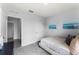 Simple bedroom design offering carpet, door to hallway, and serene blue artwork for relaxation at 1815 Waggoner St, Kissimmee, FL 34744