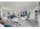 Bright and spacious open-concept living room with a large rug, a modern sofa, and a dining area at 1815 Waggoner St, Kissimmee, FL 34744