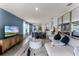 A spacious and airy open-concept living area, with natural light and modern furnishings and an open-concept kitchen at 1815 Waggoner St, Kissimmee, FL 34744