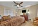 Bedroom with a ceiling fan, TV, and dresser at 185 Scottsdale Sq # 185, Winter Park, FL 32792