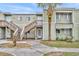A charming townhouse with light green siding, wooden stairs, and a well-manicured lawn at 185 Scottsdale Sq # 185, Winter Park, FL 32792