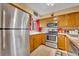 Cozy kitchen with stainless steel appliances, light oak cabinets and tile countertops at 185 Scottsdale Sq # 185, Winter Park, FL 32792