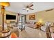 Well-lit living room with a ceiling fan and sliding doors to the outside at 185 Scottsdale Sq # 185, Winter Park, FL 32792