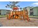 Community playground featuring a wooden play structure with slides, stairs, and platforms on a mulch surface at 185 Scottsdale Sq # 185, Winter Park, FL 32792