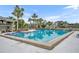 Large community swimming pool surrounded by palm trees and lounge chairs for residents' enjoyment at 185 Scottsdale Sq # 185, Winter Park, FL 32792