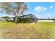 Wide shot of a backyard featuring a screened-in pool and patio, providing outdoor living space at 2829 Autumn Breeze Way, Kissimmee, FL 34744
