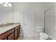Bathroom featuring granite countertop, a large mirror, a shower and a toilet at 2829 Autumn Breeze Way, Kissimmee, FL 34744