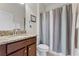 Bathroom featuring a granite countertop, neutral shower curtain, and standard toilet at 2829 Autumn Breeze Way, Kissimmee, FL 34744