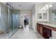 Bathroom featuring a granite countertop, tile floors, and glass shower at 2829 Autumn Breeze Way, Kissimmee, FL 34744