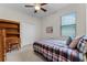 Bedroom showcasing a ceiling fan, window with blinds, and neutral carpet at 2829 Autumn Breeze Way, Kissimmee, FL 34744