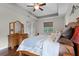 Bedroom featuring a ceiling fan, tray ceiling, and hardwood floors at 2829 Autumn Breeze Way, Kissimmee, FL 34744
