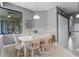 Bright dining area with natural light, white table with seating for six, and tile floors at 2829 Autumn Breeze Way, Kissimmee, FL 34744