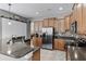 Spacious kitchen featuring stainless steel appliances, granite countertops, ample cabinetry, and bar stool seating at 2829 Autumn Breeze Way, Kissimmee, FL 34744