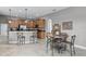 Open kitchen with breakfast bar, wooden cabinets, and stainless steel appliances at 2829 Autumn Breeze Way, Kissimmee, FL 34744