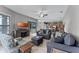 Open-concept living room featuring tile floors, neutral decor, and access to the outdoors at 2829 Autumn Breeze Way, Kissimmee, FL 34744