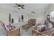 Expansive living room featuring wicker seating, plush carpeting, and abundant natural light at 2829 Autumn Breeze Way, Kissimmee, FL 34744