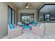 Cozy covered patio features four cushioned wicker chairs and an ottoman for relaxing outdoors at 2829 Autumn Breeze Way, Kissimmee, FL 34744