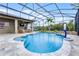 Inviting screened-in pool with a stone waterfall, landscaping, and a basketball hoop for outdoor fun at 2829 Autumn Breeze Way, Kissimmee, FL 34744
