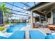 Expansive screened pool area features a hot tub, outdoor seating, and a barbecue grill at 2829 Autumn Breeze Way, Kissimmee, FL 34744