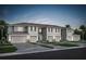 Charming townhome exterior with individual garages, lush lawns and sidewalks at 3133 Emerald Acres Ln, Sanford, FL 32771