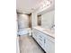 Modern bathroom features a double sink vanity and tiled shower-tub combination at 3171 Cup Dr, Lakeland, FL 33803