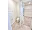 Neutral toned bathroom featuring a toilet, a towel rack, and a glimpse into the closet at 3171 Cup Dr, Lakeland, FL 33803