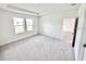 Bright bedroom with plush carpet and a view from its large windows at 3171 Cup Dr, Lakeland, FL 33803