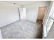 Bright bedroom featuring neutral carpet, a walk-in closet, and a large window for natural light at 3171 Cup Dr, Lakeland, FL 33803