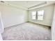 Spacious bedroom featuring soft carpeting and natural light from two large windows at 3171 Cup Dr, Lakeland, FL 33803