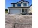 Charming two-story home with a two-car garage and unfinished front yard at 3171 Cup Dr, Lakeland, FL 33803