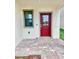 Inviting front porch with a red door and neutral-toned brick pavers at 3171 Cup Dr, Lakeland, FL 33803