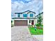 Charming two-story home with a manicured lawn, brick driveway and a two car garage at 3171 Cup Dr, Lakeland, FL 33803