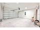 Spacious two car garage featuring neutral paint, recessed lighting, and a metal garage door at 3171 Cup Dr, Lakeland, FL 33803