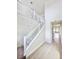 Bright hallway with neutral walls, white banisters, and large gray floor tiles at 3171 Cup Dr, Lakeland, FL 33803