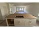 Unfinished kitchen with island, white cabinets, stainless steel sink, and long floorplan at 3171 Cup Dr, Lakeland, FL 33803