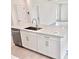 Close-up of a kitchen island featuring a sink, dishwasher, and ample storage space at 3171 Cup Dr, Lakeland, FL 33803