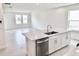 Spacious kitchen and dining area with stainless steel appliances, island with sink and ample lighting at 3171 Cup Dr, Lakeland, FL 33803