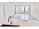 Bright, open floor plan with hardwood floors, with kitchen island in view and neutral paint at 3171 Cup Dr, Lakeland, FL 33803