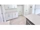 Pantry with white cabinets and quartz countertops that leads into a kitchen and dining area at 3171 Cup Dr, Lakeland, FL 33803