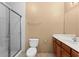 Bathroom featuring a glass shower door, white toilet, and a vanity at 3176 Feltrim Pl # 205, Kissimmee, FL 34747